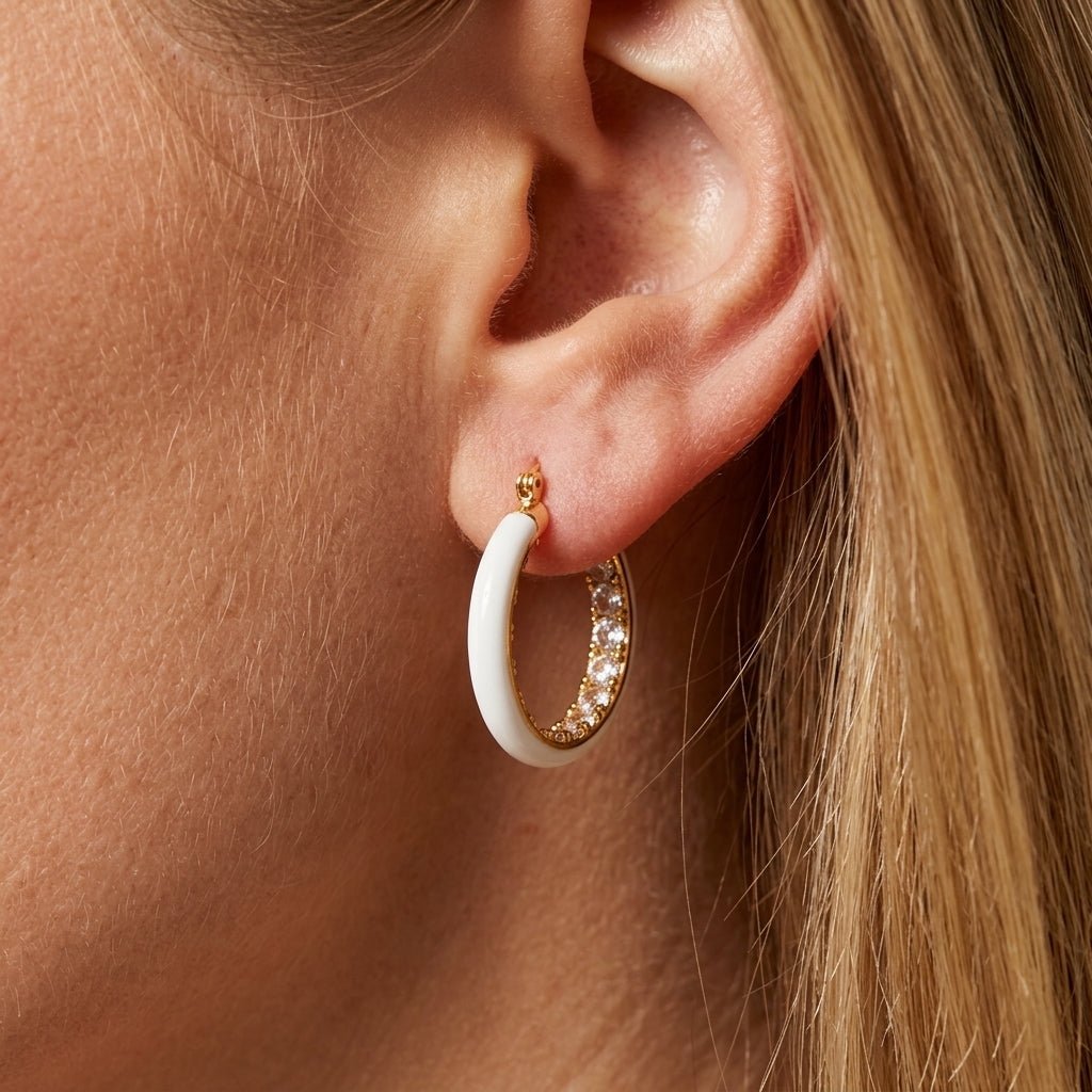 white and gold hoop earrings sleek white enamel hoop earrings framed with gold detailing and sparkling crystal accents, offering a clean polished look with a refined balance of modern simplicity and understated glamour