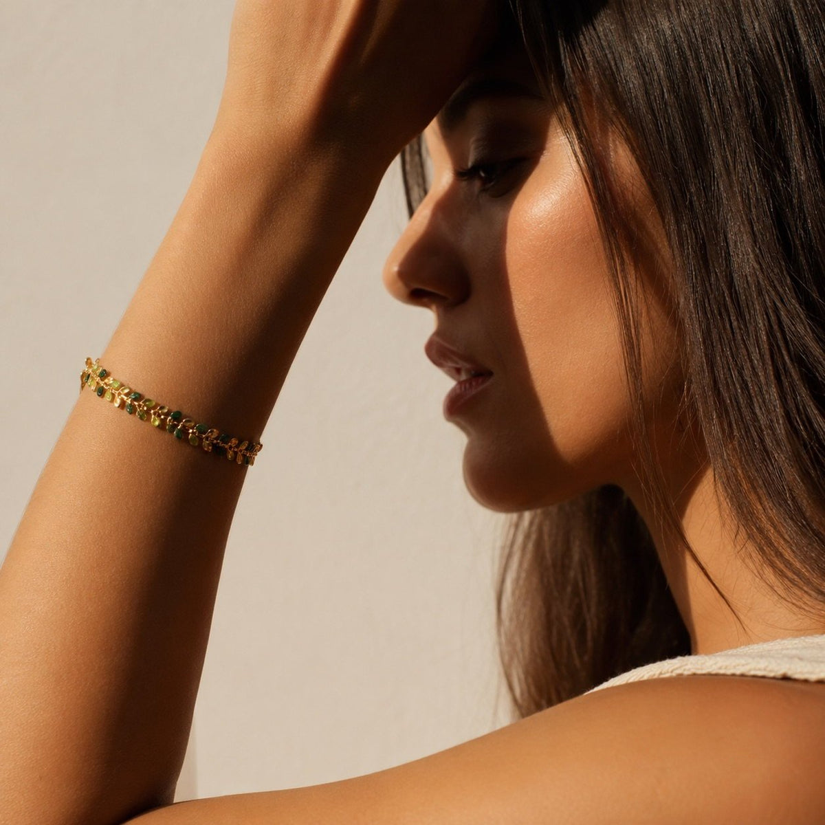 women's gold green leaf branch bracelet featuring an elegant nature-inspired design