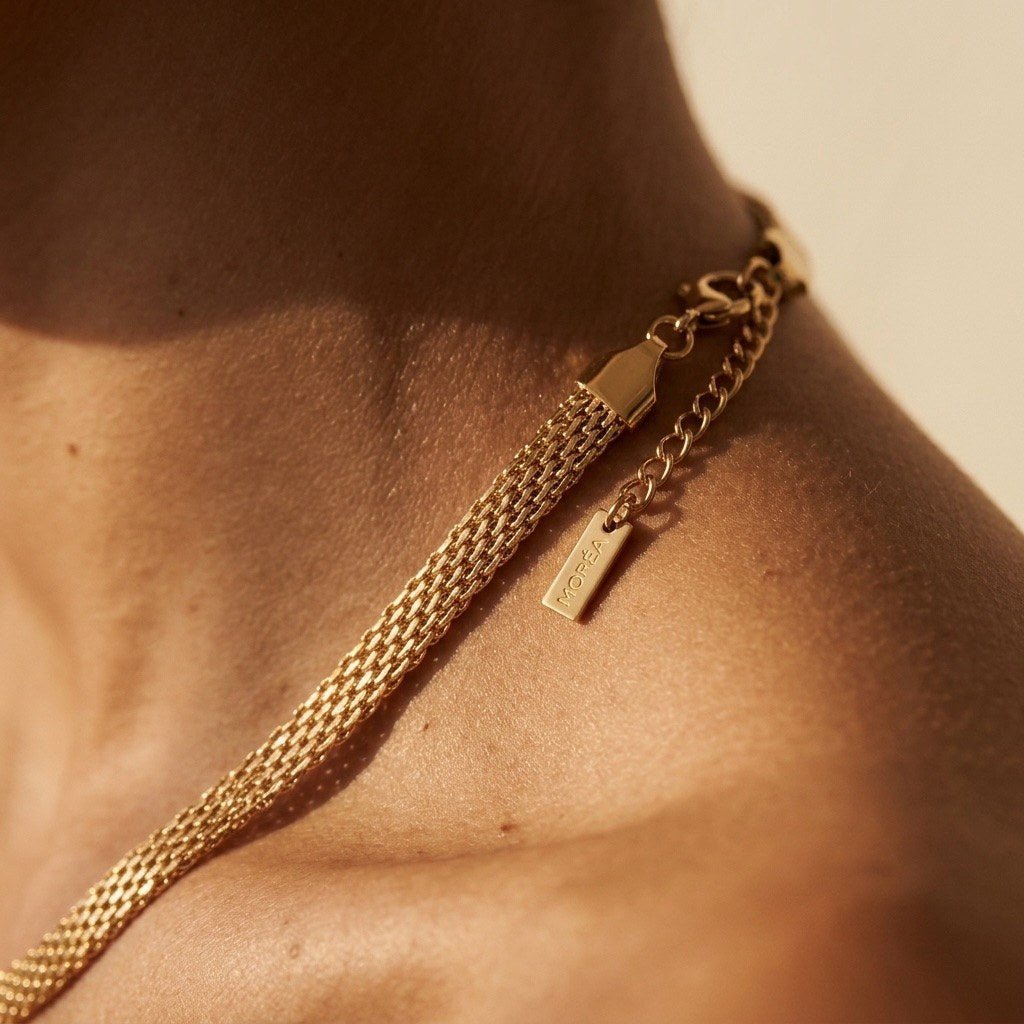 woven gold chain necklace with an intricate flexible mesh design for a sleek contemporary look