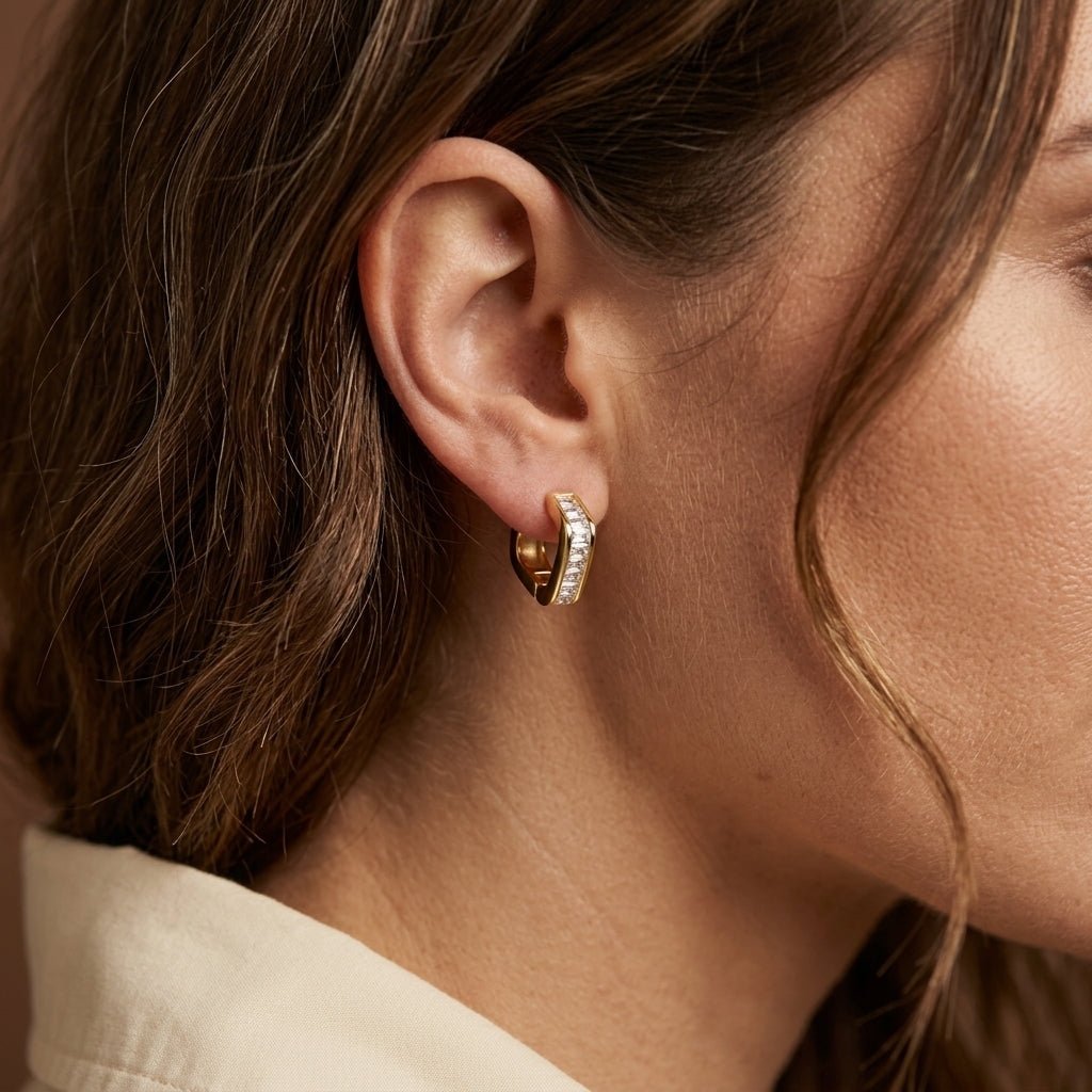 zircon earrings, gold huggie earrings worn on ear with sparkling zircon crystal detailing, elegant minimalist hoops designed for a refined everyday style