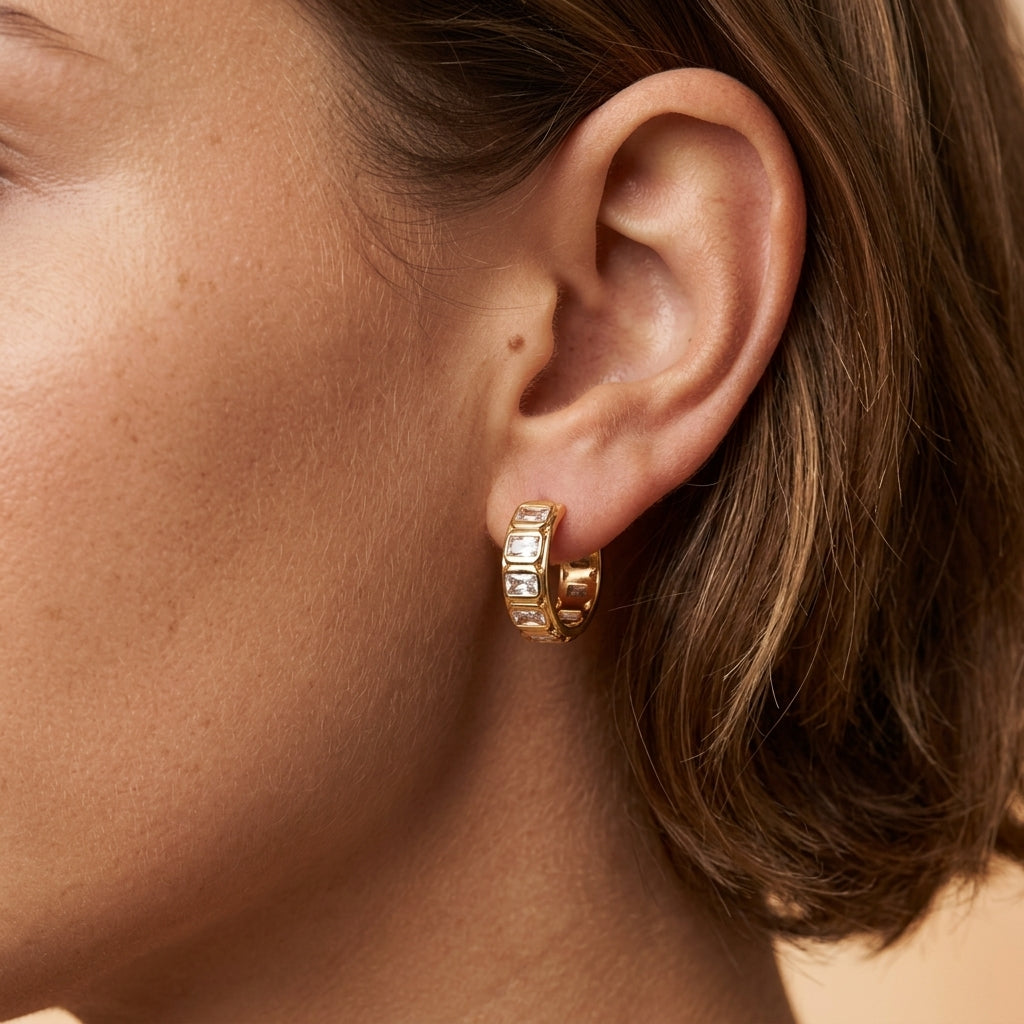 baguette cz hoop earrings featuring clear rectangular cubic zirconia stones in a bold gold setting styled on a model for a timeless jewelry look