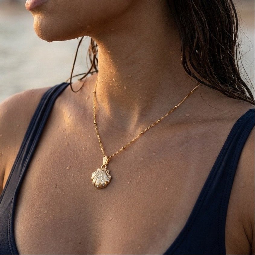 beach seashell pendant necklace in gold styled by the water for a summer look