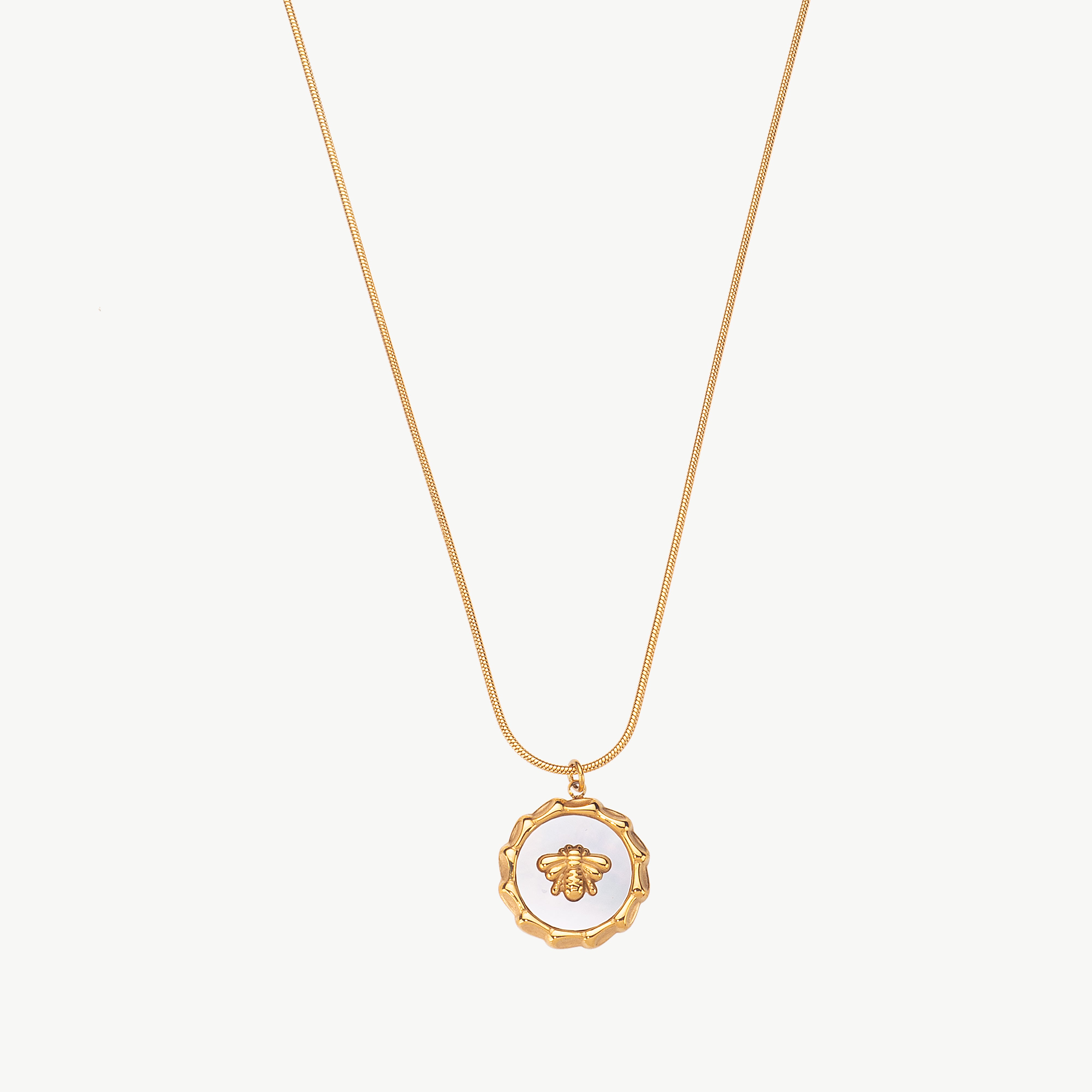bee pendant necklace in gold with small bee charm, gold bee pendant necklace styled as a bumble bee charm necklace centered on the chain