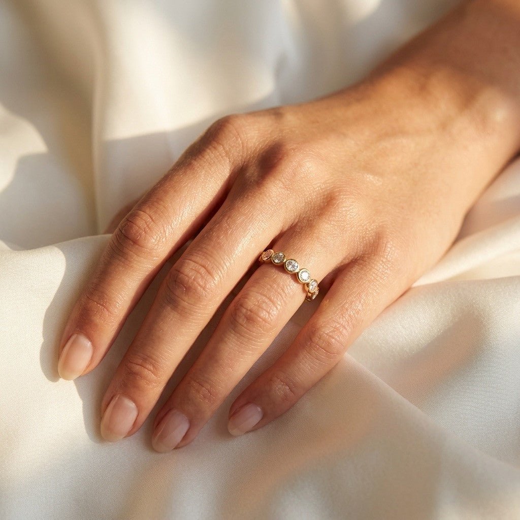 bezel set CZ ring with round cubic zirconia stones on a gold band
