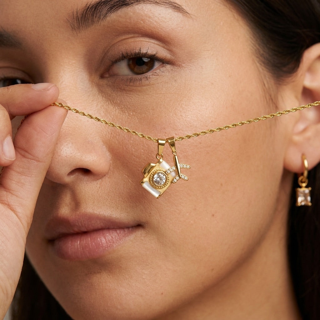 camera charm necklace in gold with sparkling stone accent