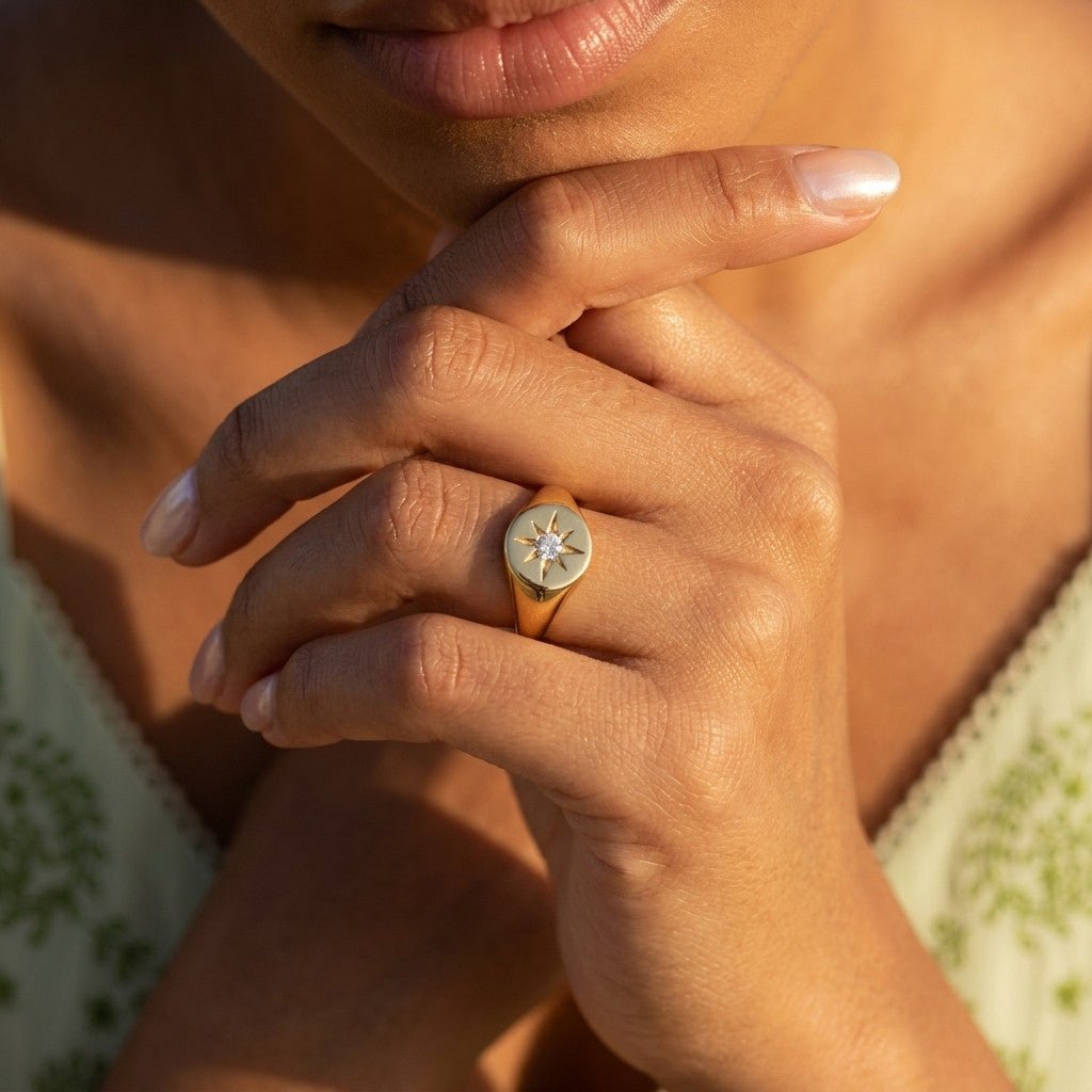 celestial signet ring with a sparkling starburst stone and polished gold finish