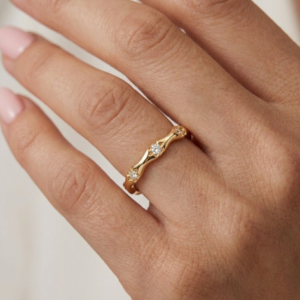 celestial stone ring with sparkling star details and a slim polished gold band