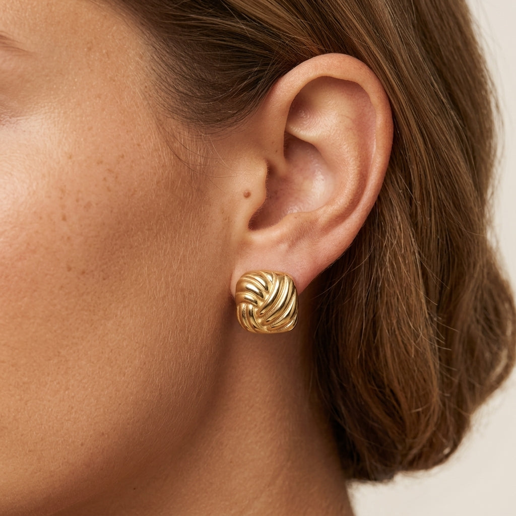 chunky gold square earrings featuring bold geometric shapes with raised twisted detailing for a modern statement jewelry look 