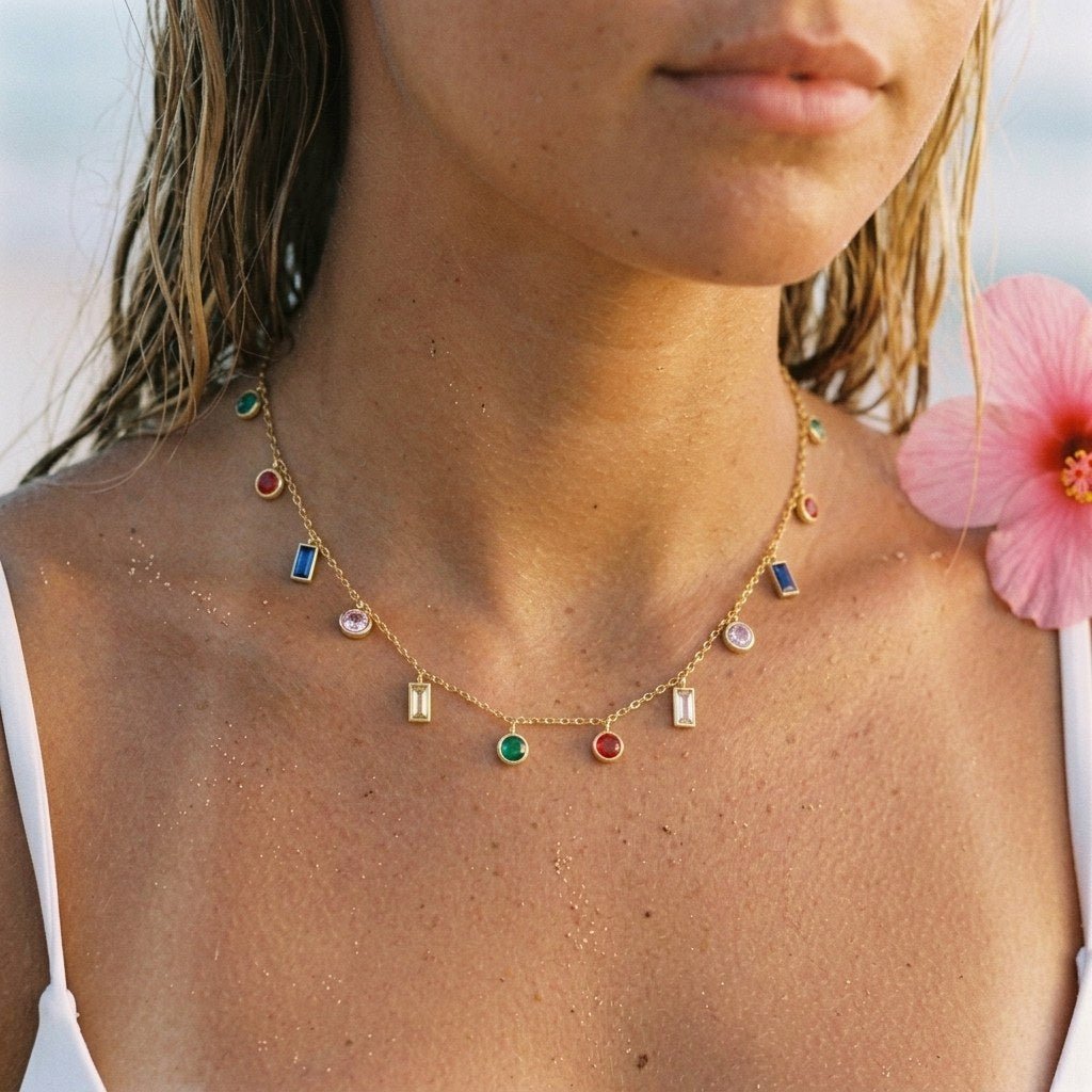 colorful gemstone charm necklace with green, red, blue and clear stones in mixed shapes