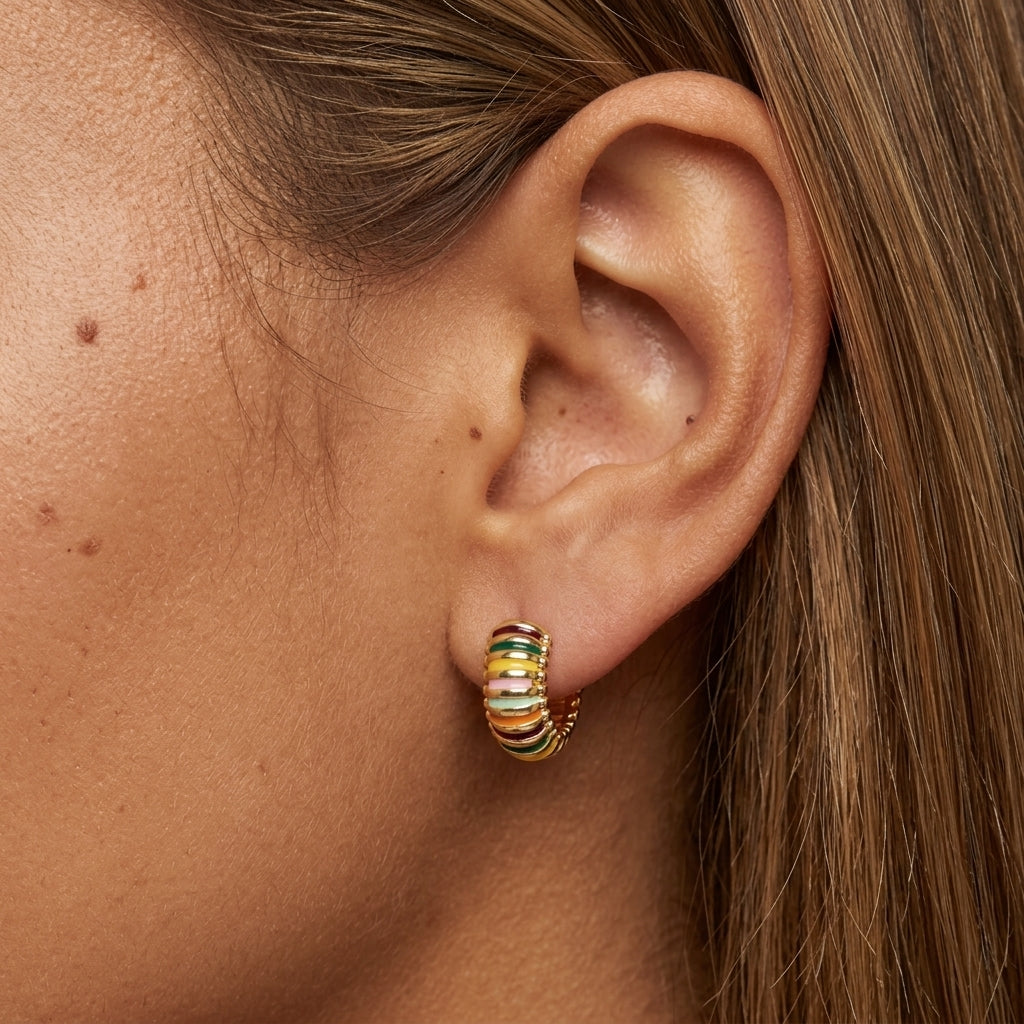 colorful huggie earrings featuring rainbow enamel bands and gold detailing