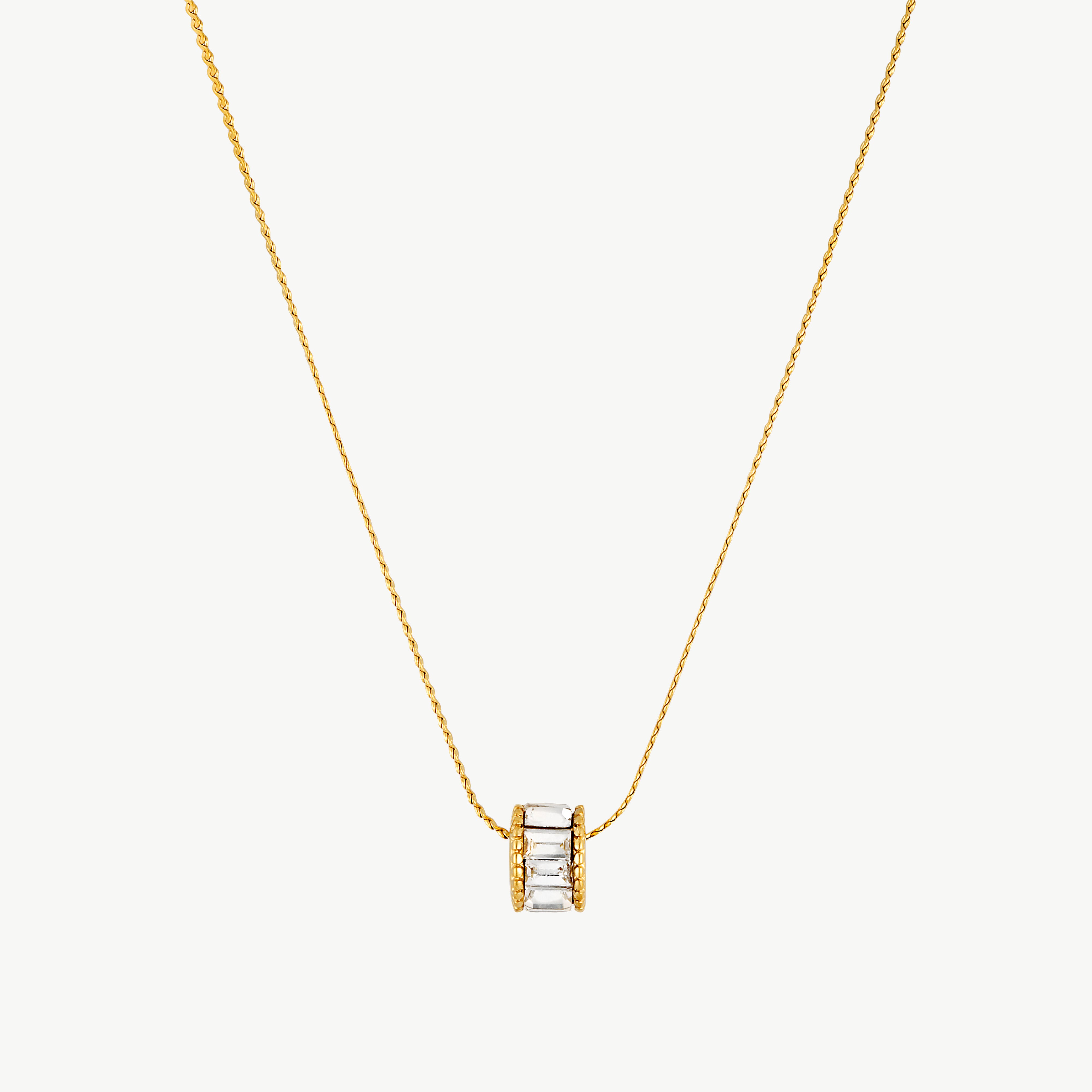 crystal pendant necklace with clear baguette style stones set in a small rectangular pendant on a delicate gold tone chain