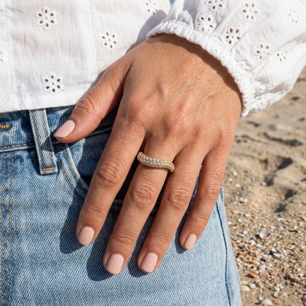 crystal set gold band with sparkling pavé stones and a smooth curved statement design