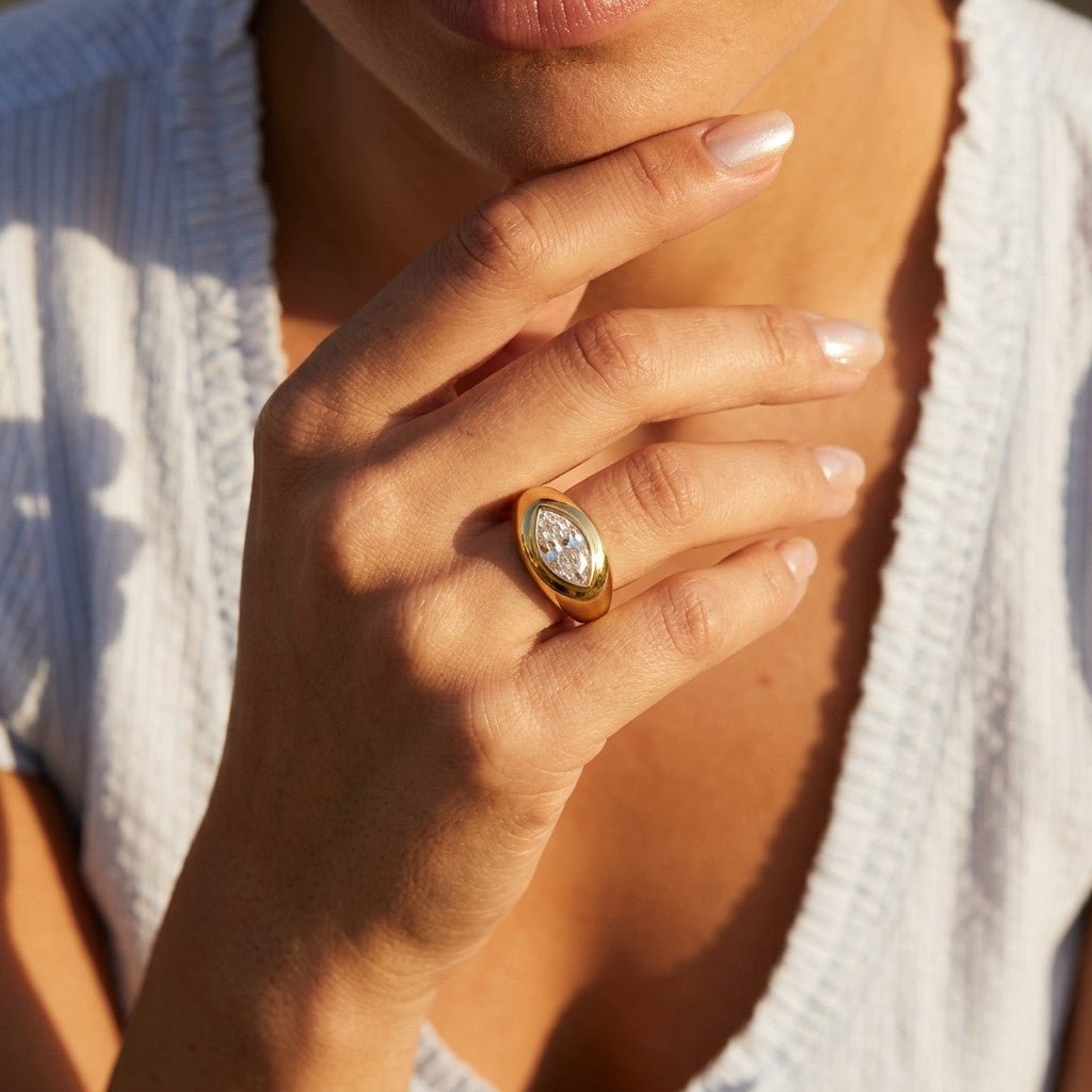 cubic zirconia gold ring with a sparkling marquise shaped center and bold polished setting