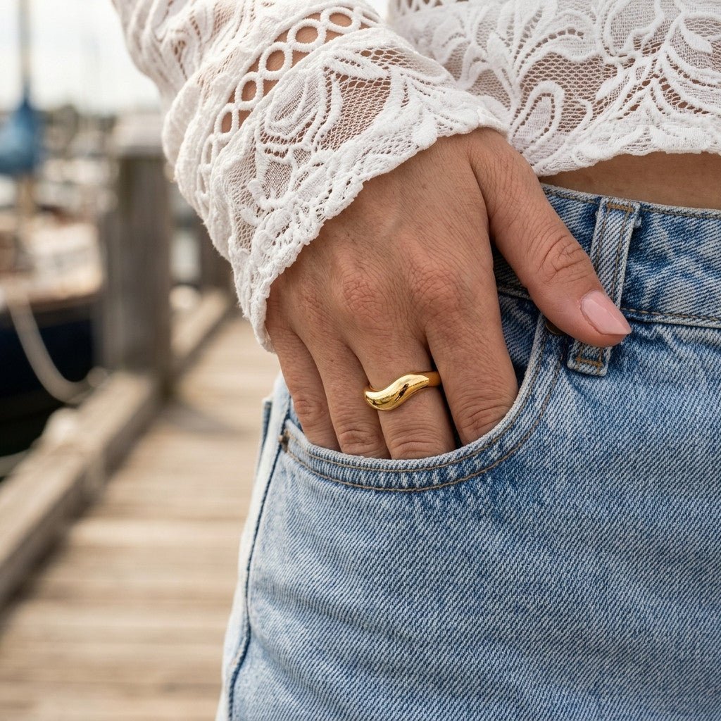 curved gold ring with a fluid wave shape and bold polished band