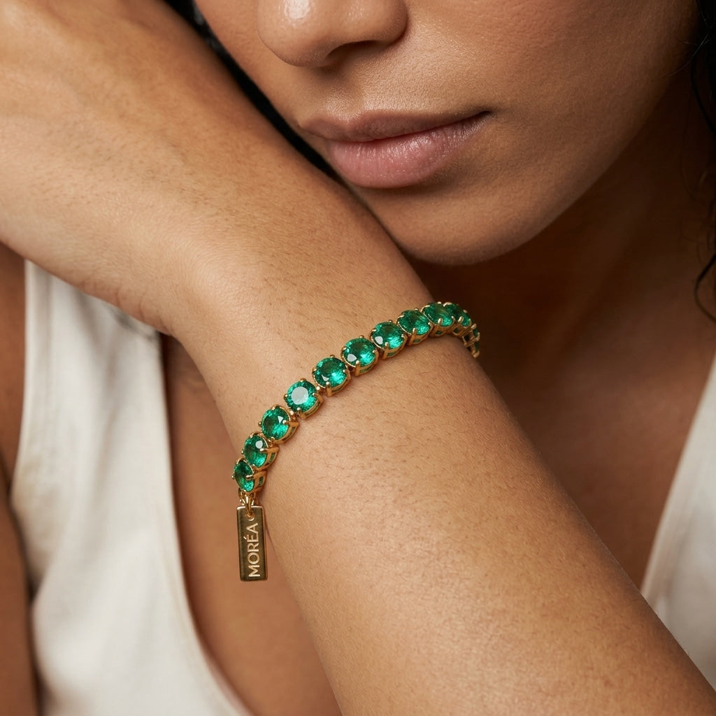 dainty green tennis bracelet for women featuring a delicate row of brilliant green crystals with gold accents for refined everyday jewelry