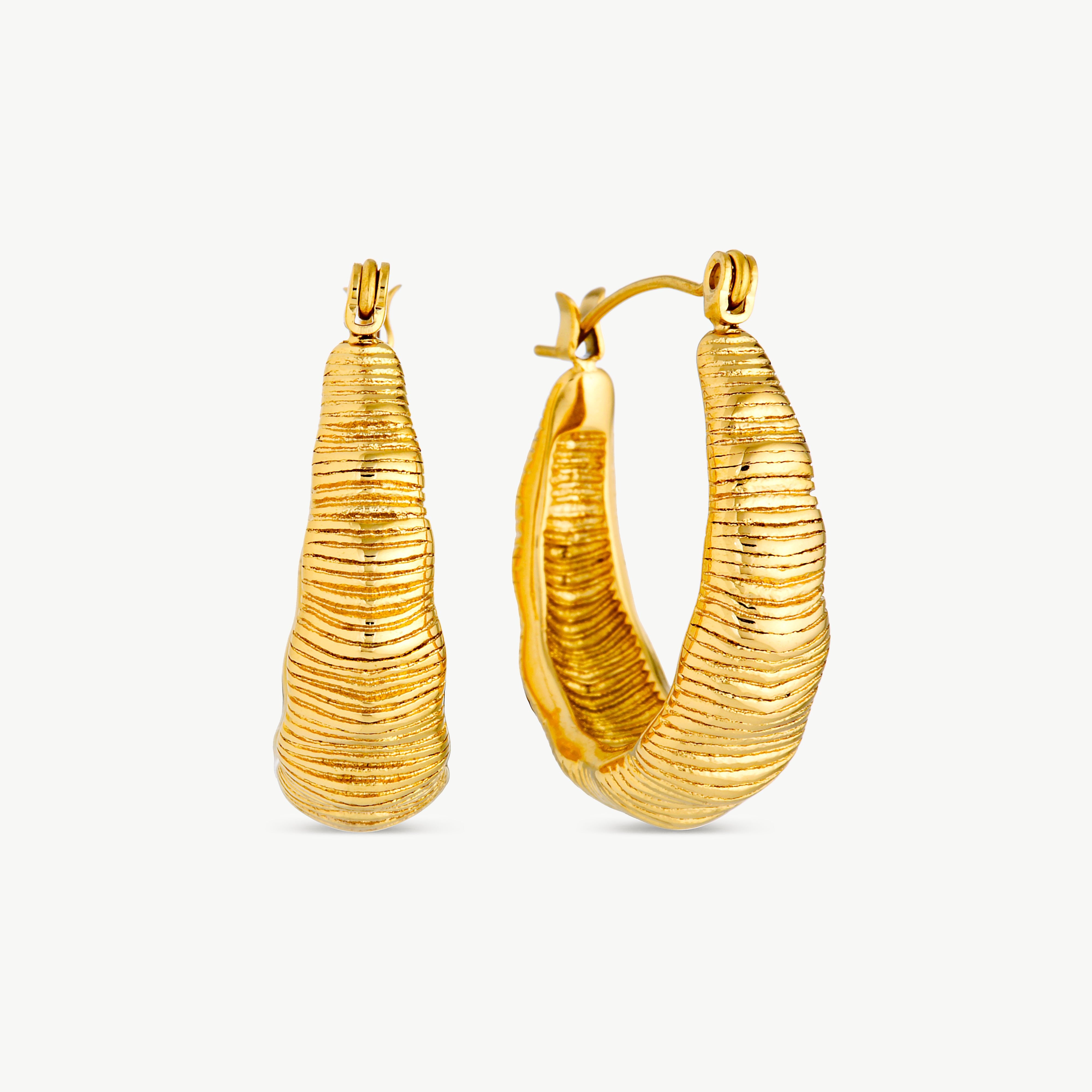 dome earrings with chunky curved gold hoops and finely ridged textured detailing creating a sculptural statement design