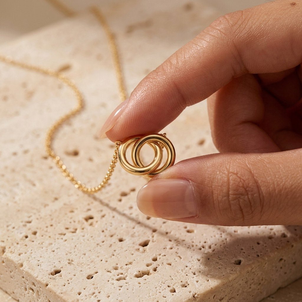 double ring pendant necklace featuring intertwined gold-tone circles on a delicate chain