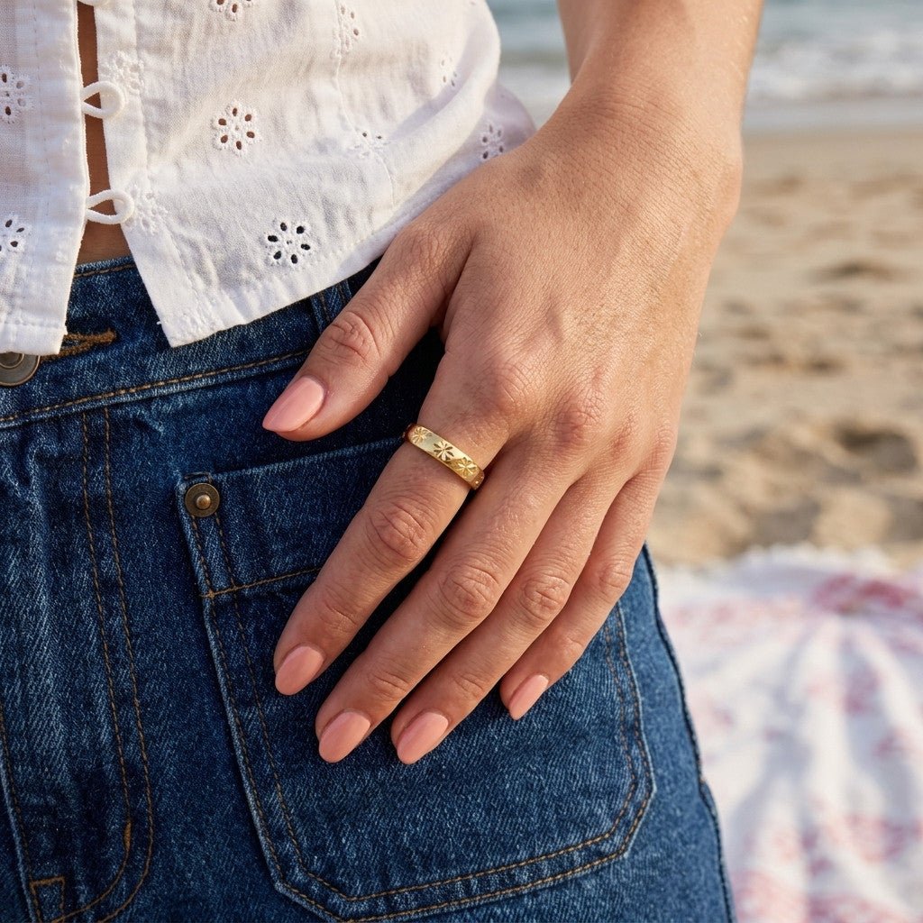 engraved star ring with repeating celestial details on a polished gold band