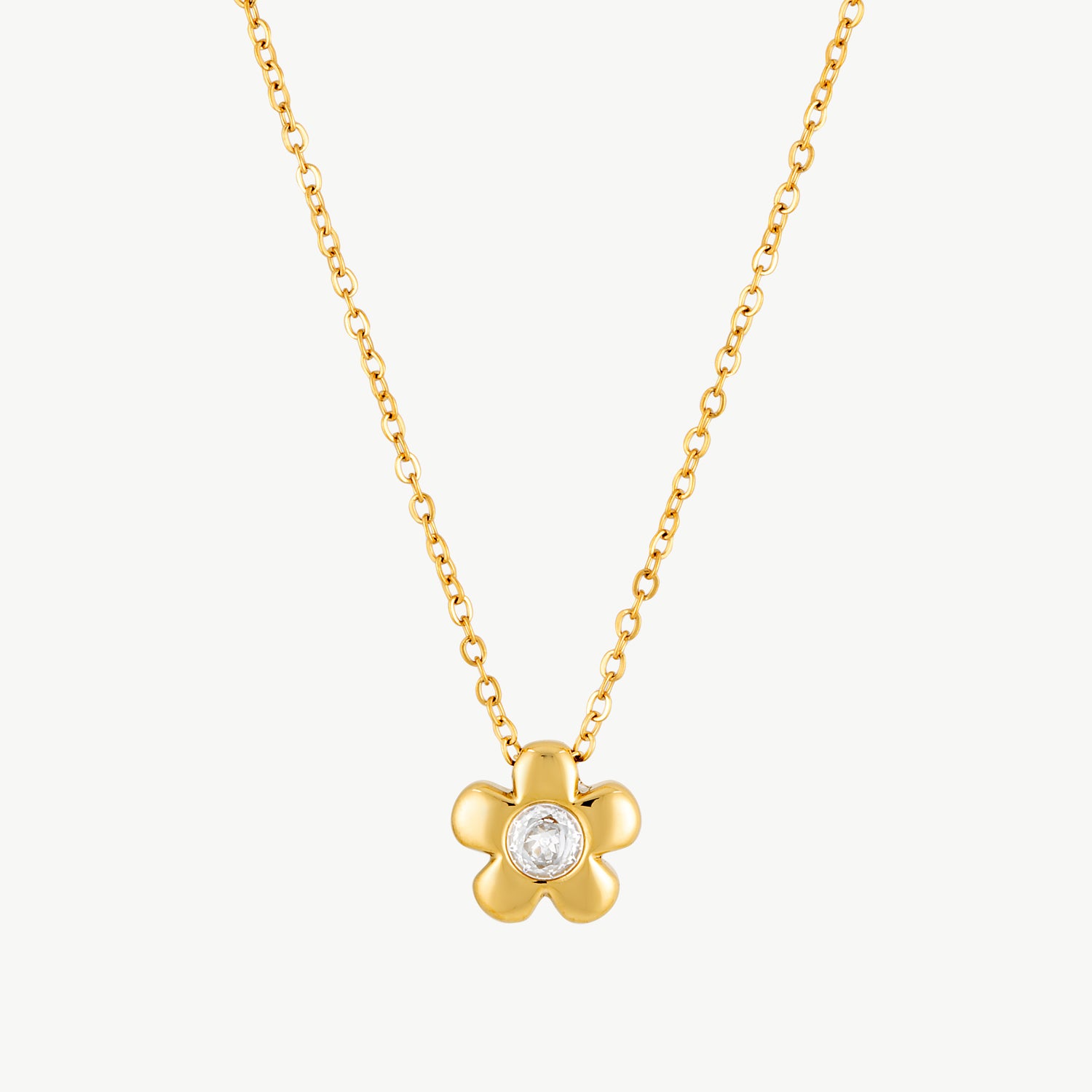 flower necklace with a gold flower pendant and sparkling crystal center