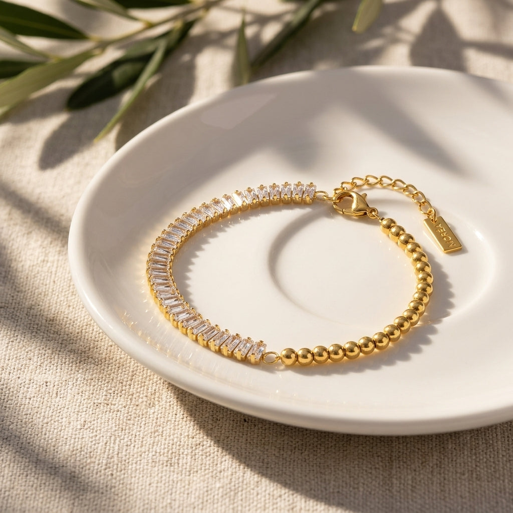 gold baguette crystal bracelet featuring a curved row of brilliant rectangular cubic zirconia stones and smooth gold beads for sophisticated feminine jewelry