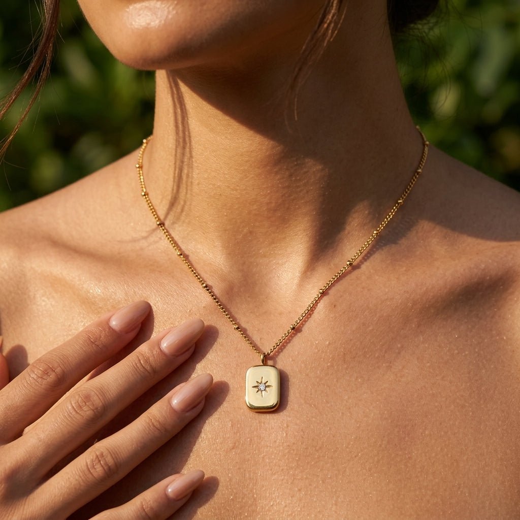 gold celestial pendant necklace featuring a sparkling starburst motif