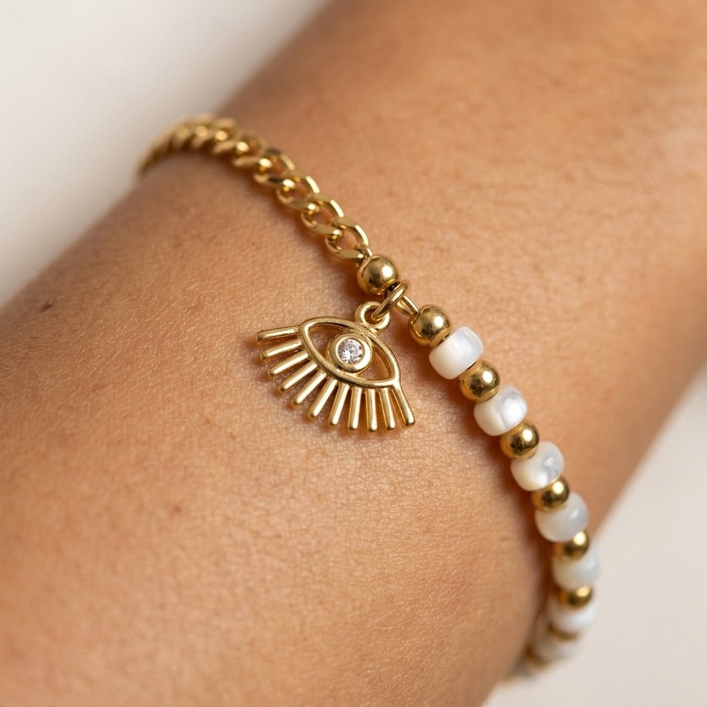 gold evil eye charm bracelet with beaded detailing