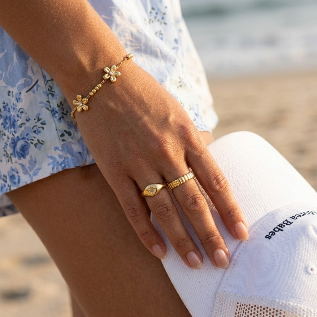gold flower charm chain bracelet featuring elegant five petal floral motifs with sparkling crystal accents and dainty gold beads for sophisticated everyday jewelry 