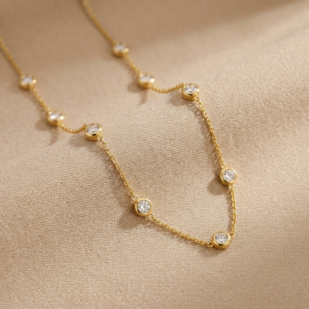 gold gemstone station necklace with colorful stones on a delicate gold chain