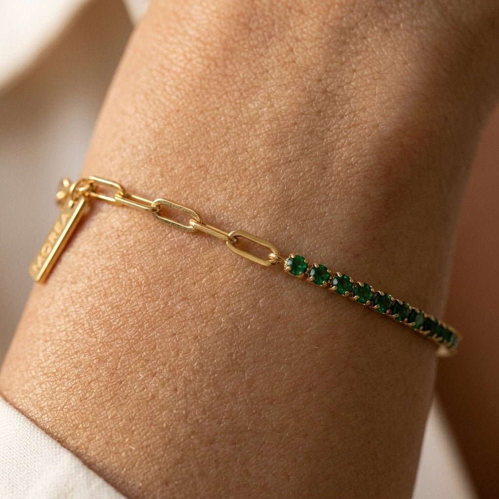 delicate gold link bracelet with sparkling green accents