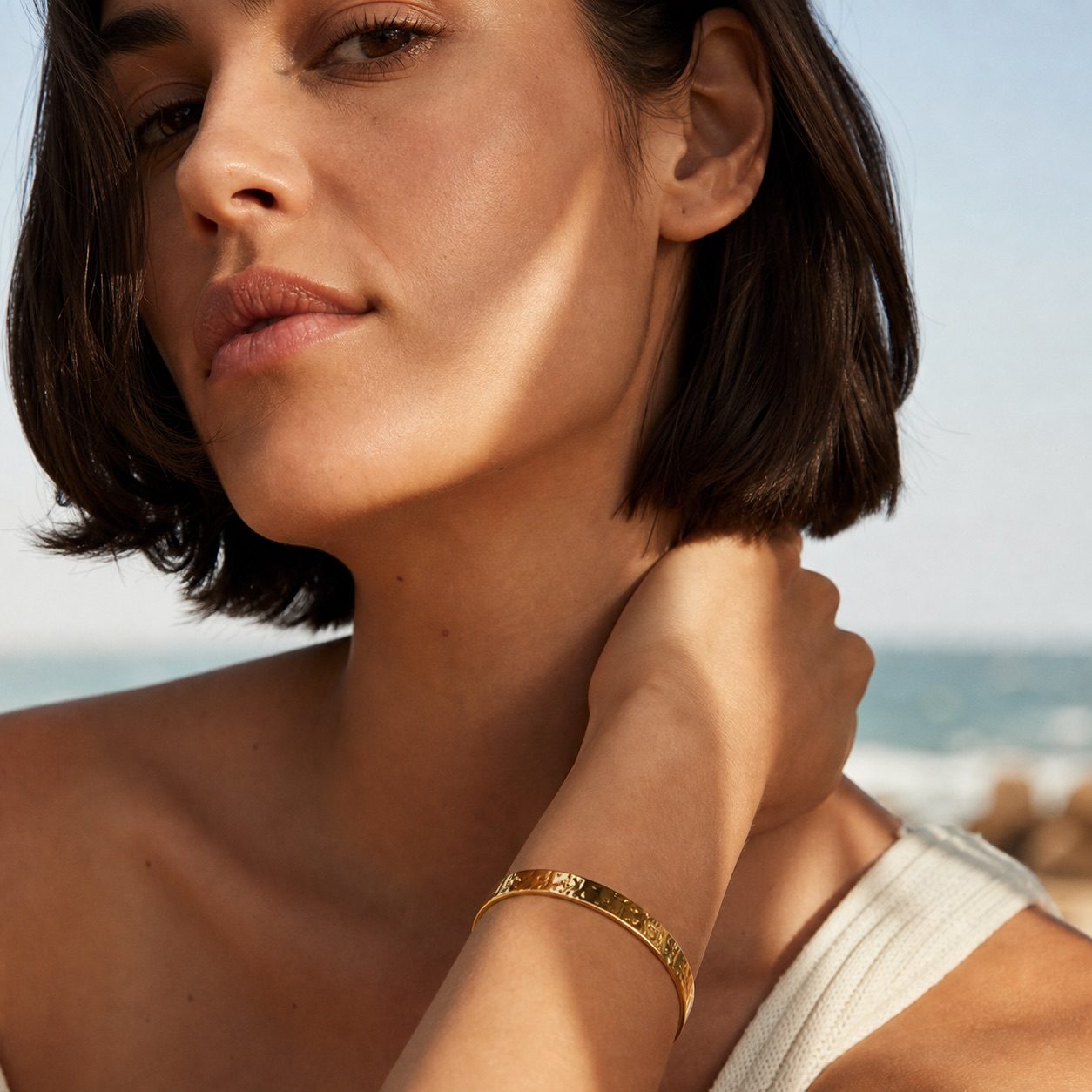 gold hammered bangle bracelet featuring a modern textured surface with a polished finish