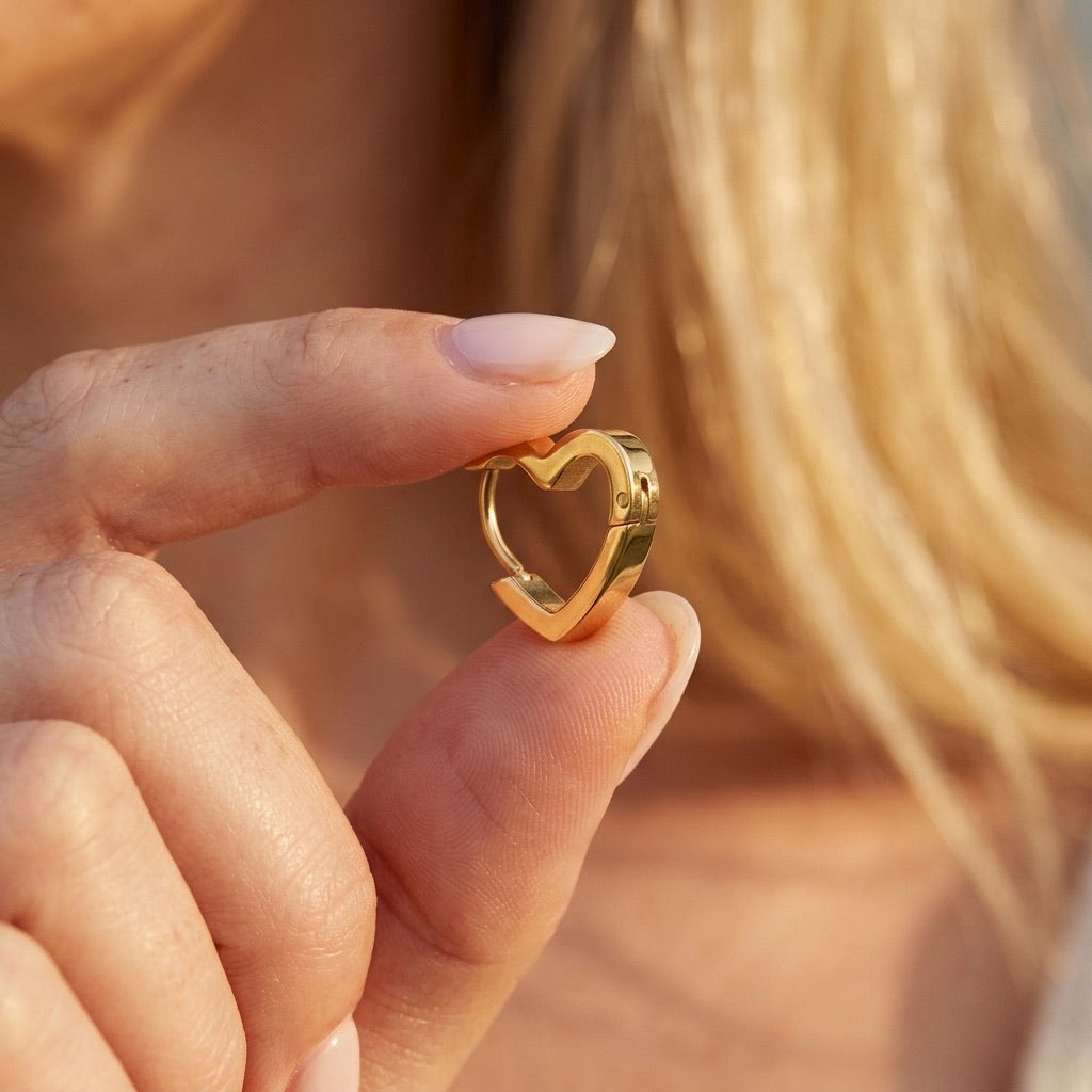 gold heart hoop earrings with an open heart shaped design