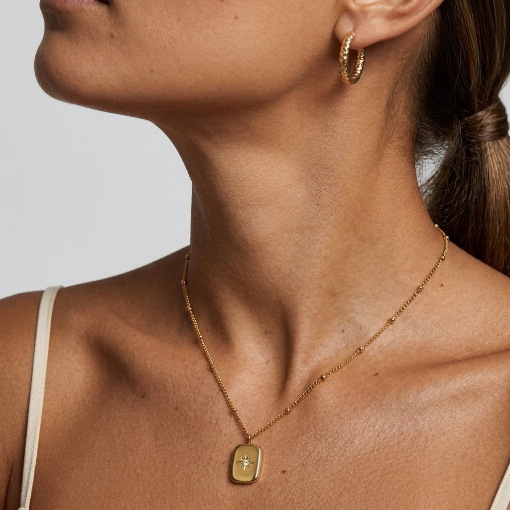 gold north star pendant necklace with sparkling center stone