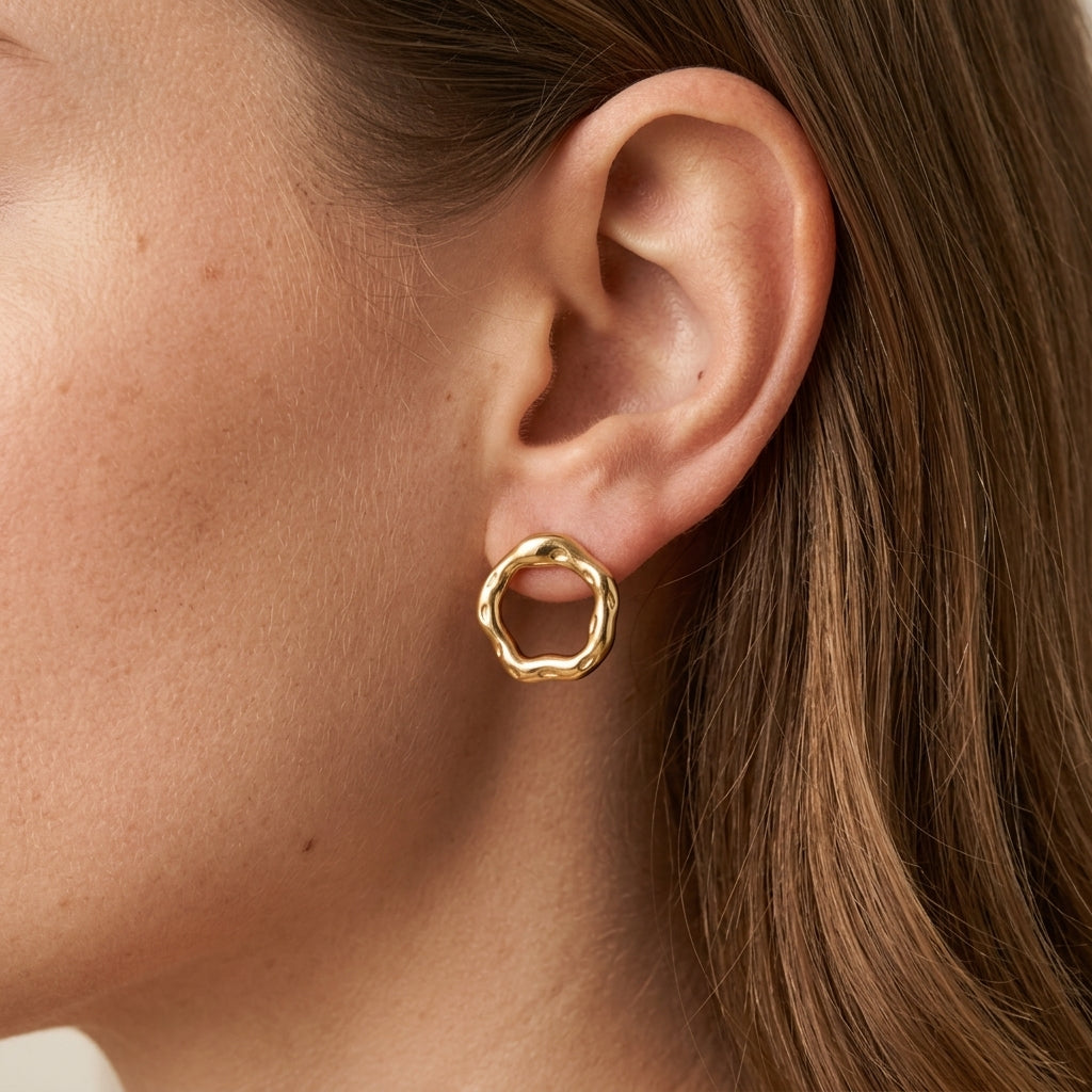 gold open circle earrings featuring a sculptural rounded shape