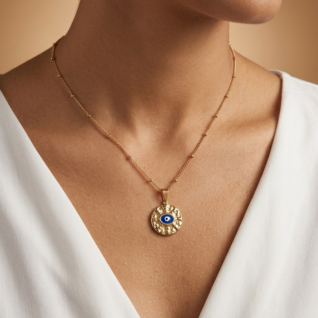 gold protection necklace with a traditional blue evil eye charm on a delicate chain