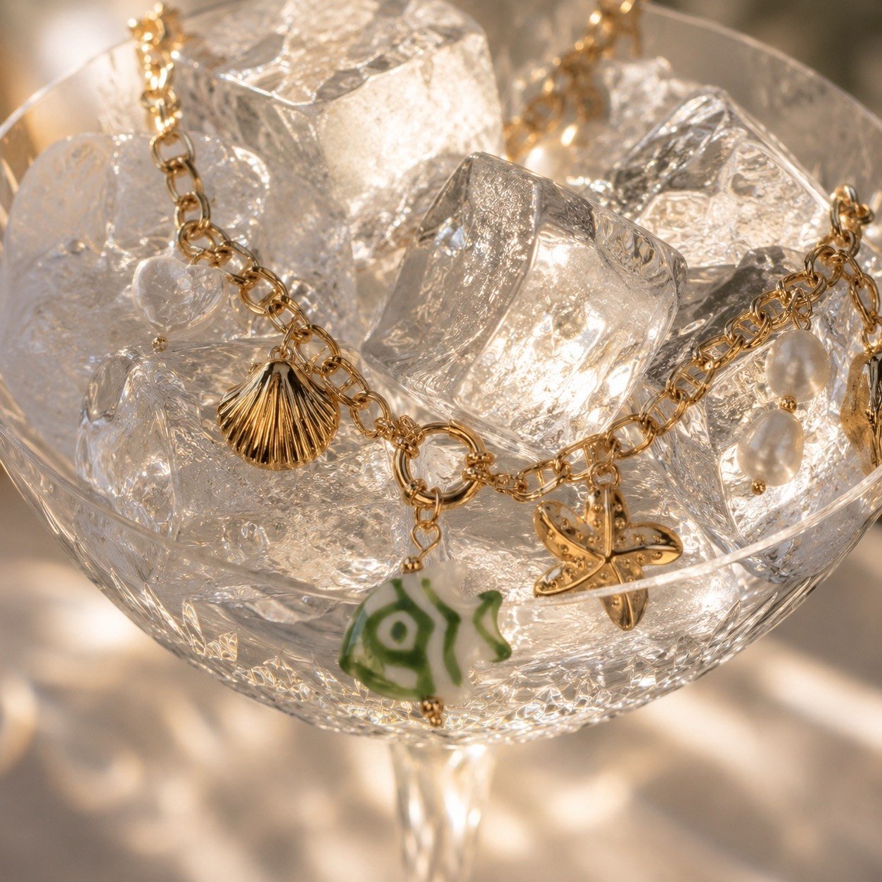 gold sea charm necklace featuring playful marine-inspired charms and pearl details