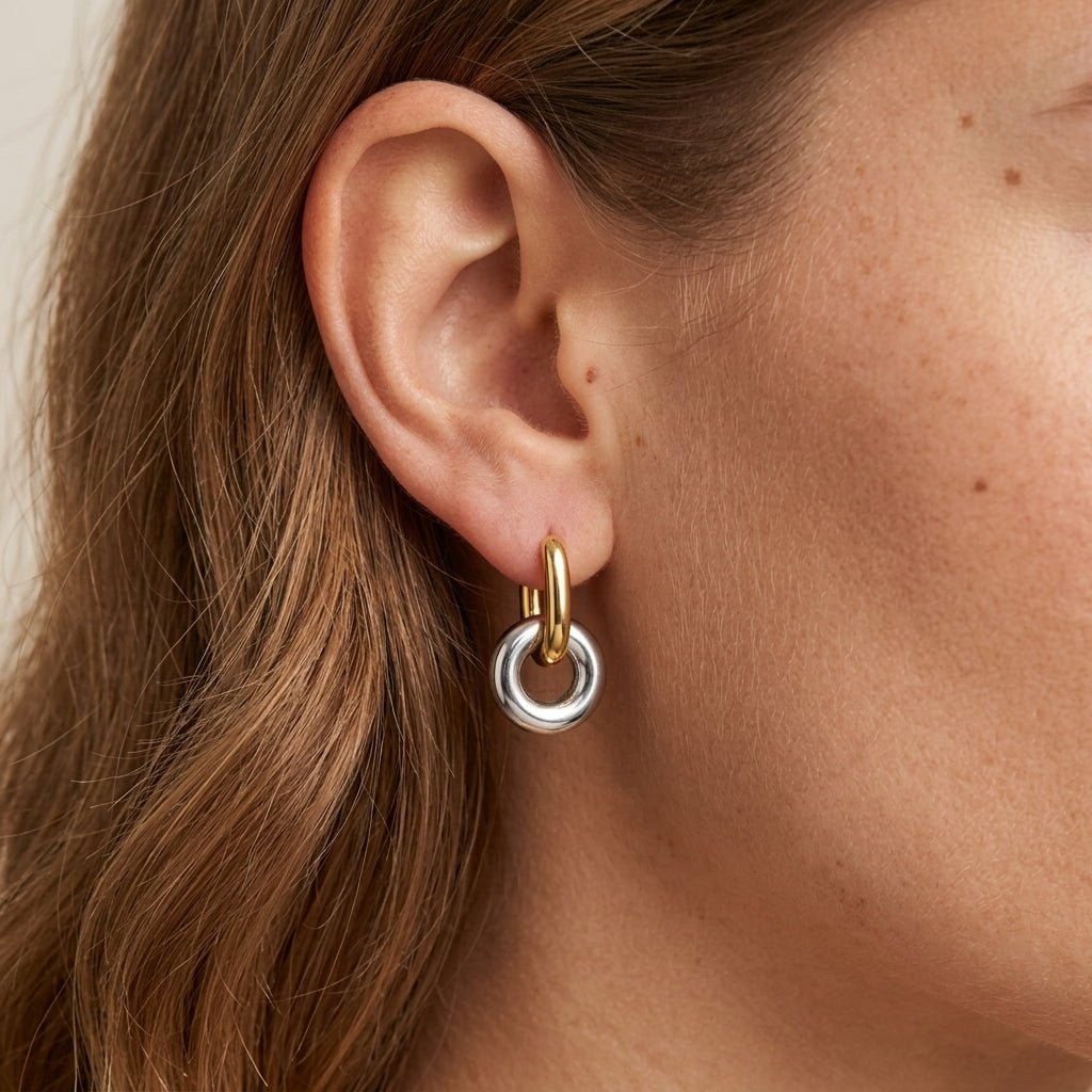gold and silver circle earrings with a modern drop hoop design