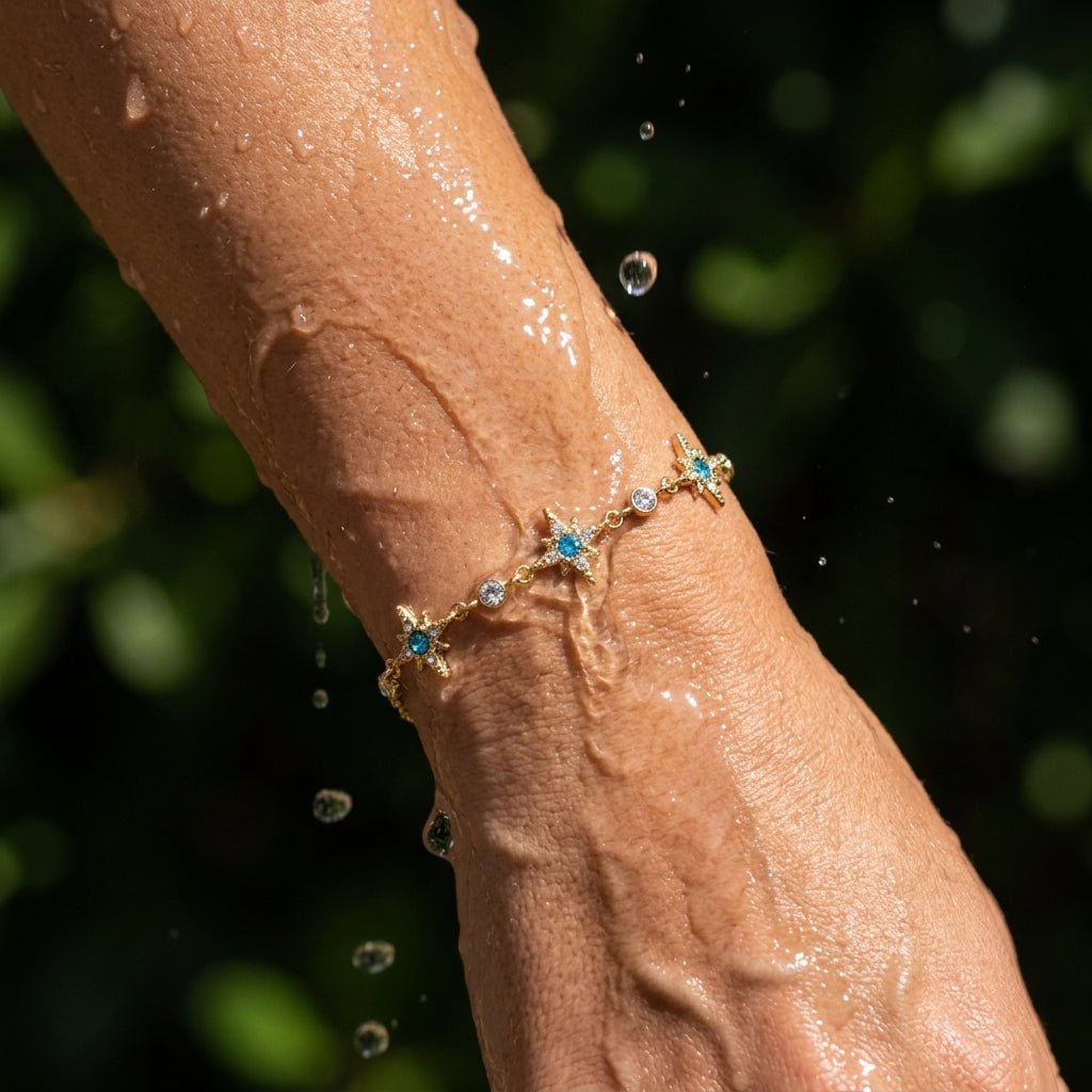 gold star charm bracelet with blue stones and sparkling crystal accents
