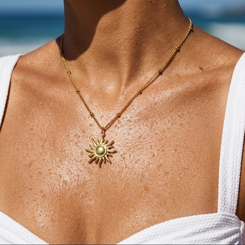 gold sunburst pendant necklace with a detailed sun pendant