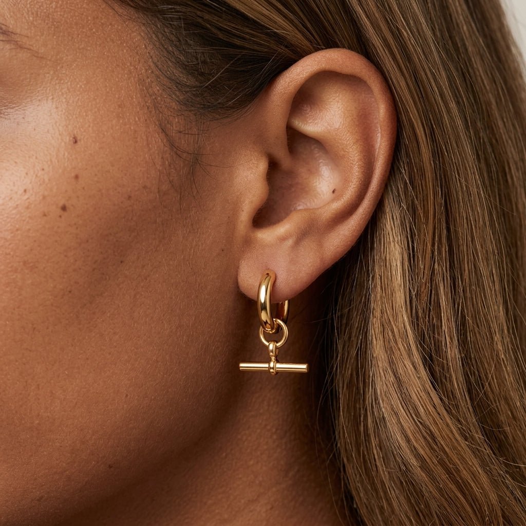 gold t bar hoop earrings with a dangling horizontal bar charm