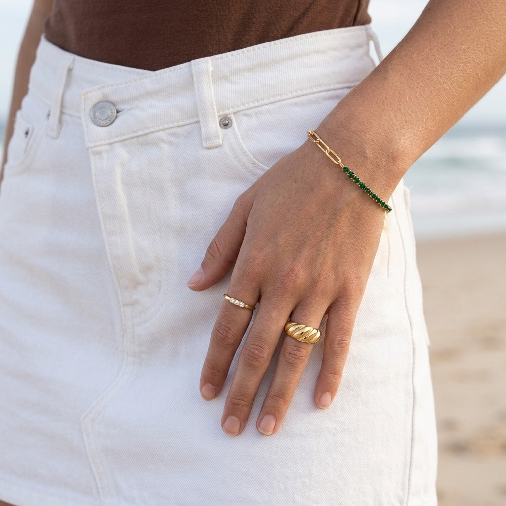 green crystal gold bracelet featuring a row of vibrant green round crystals set in polished gold with delicate paperclip chain links for modern feminine jewelry