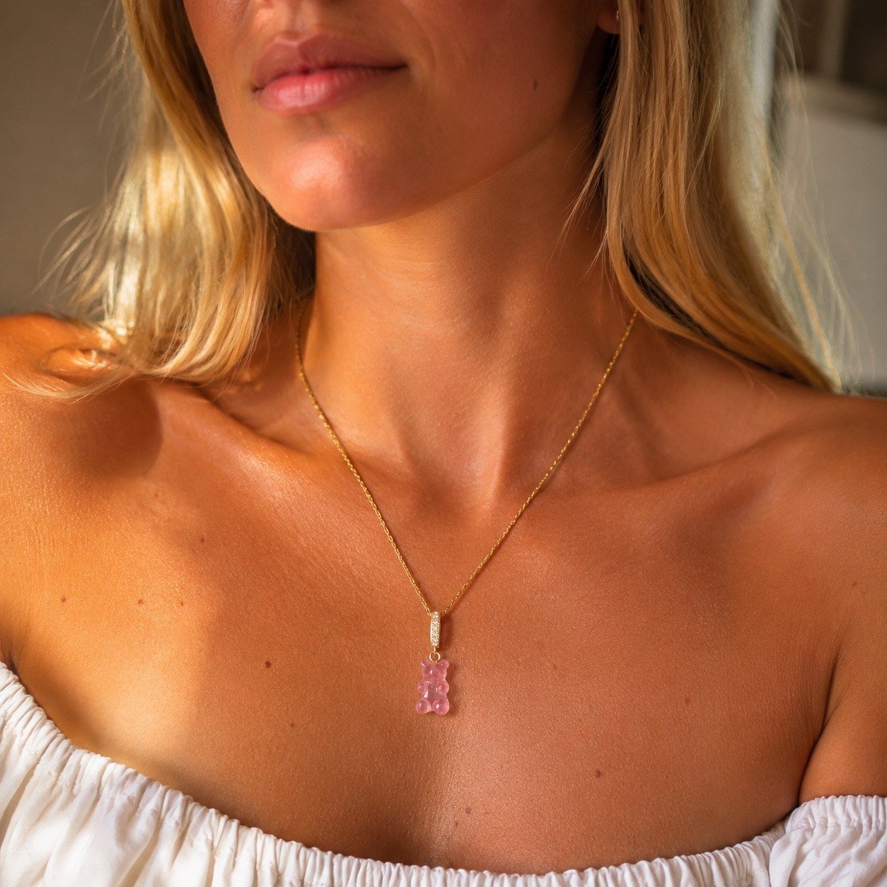 gummy bear pendant necklace featuring a playful pink bear charm and fine gold chain