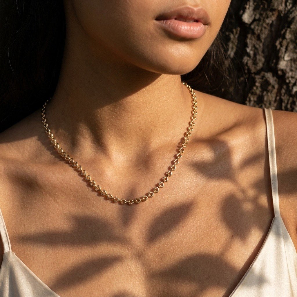 heart shaped link chain necklace in gold designed as an elegant standalone jewelry piece