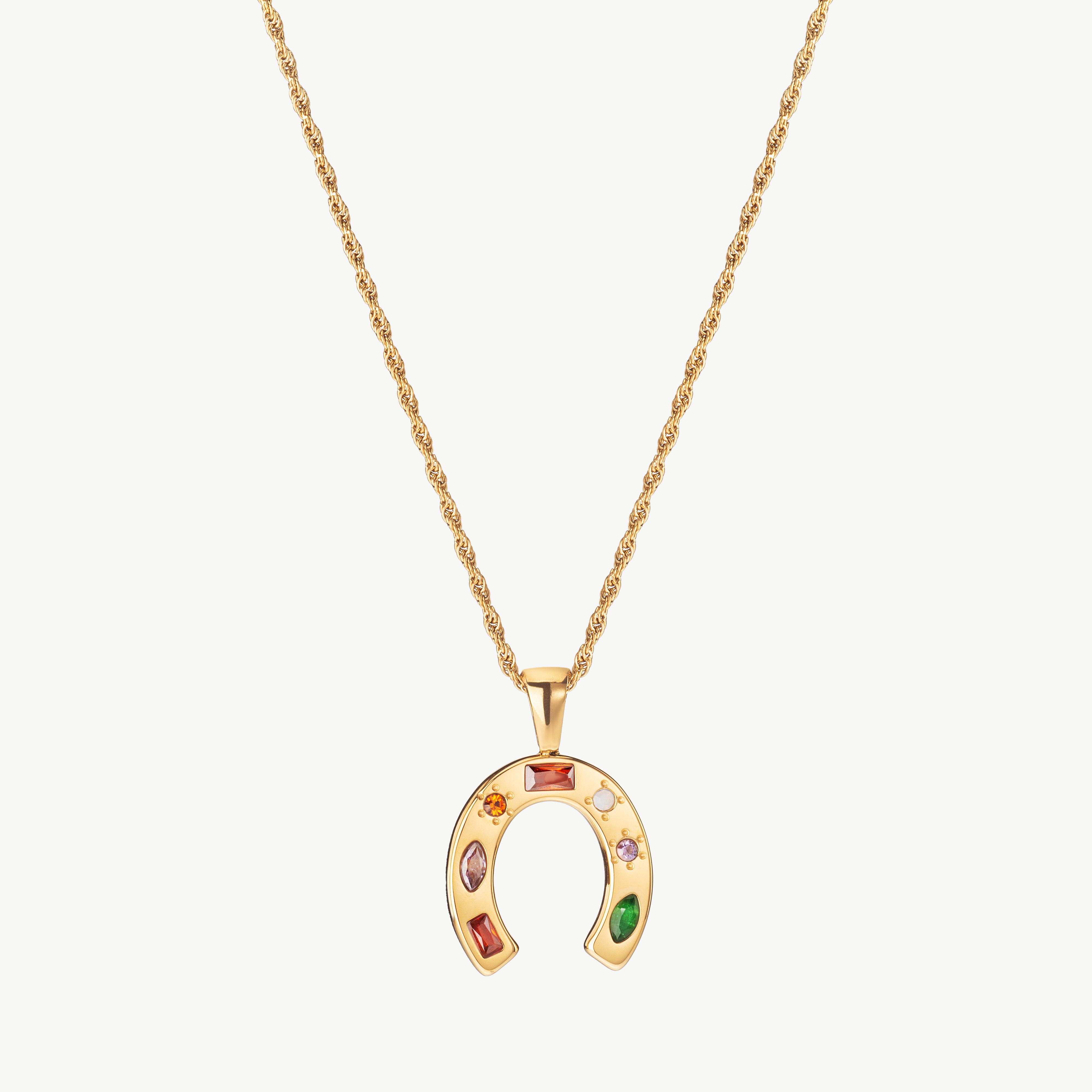 horseshoe necklace in gold with curved charm, gold horseshoe necklace with polished finish and dainty horseshoe necklace styling