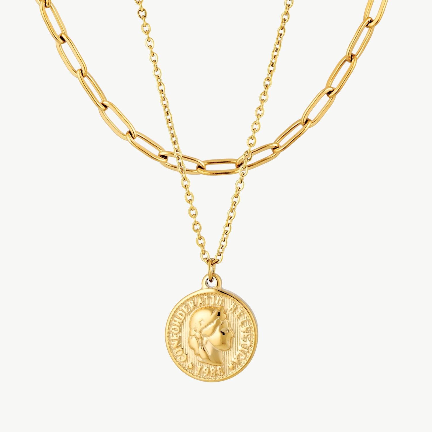 layered coin necklace with gold coin pendant on a delicate chain layered with a bold elongated gold link chain