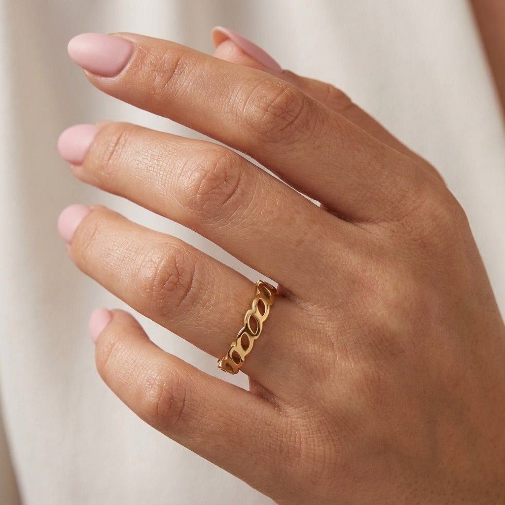 leaf motif gold ring with repeating open leaf details and a delicate polished band