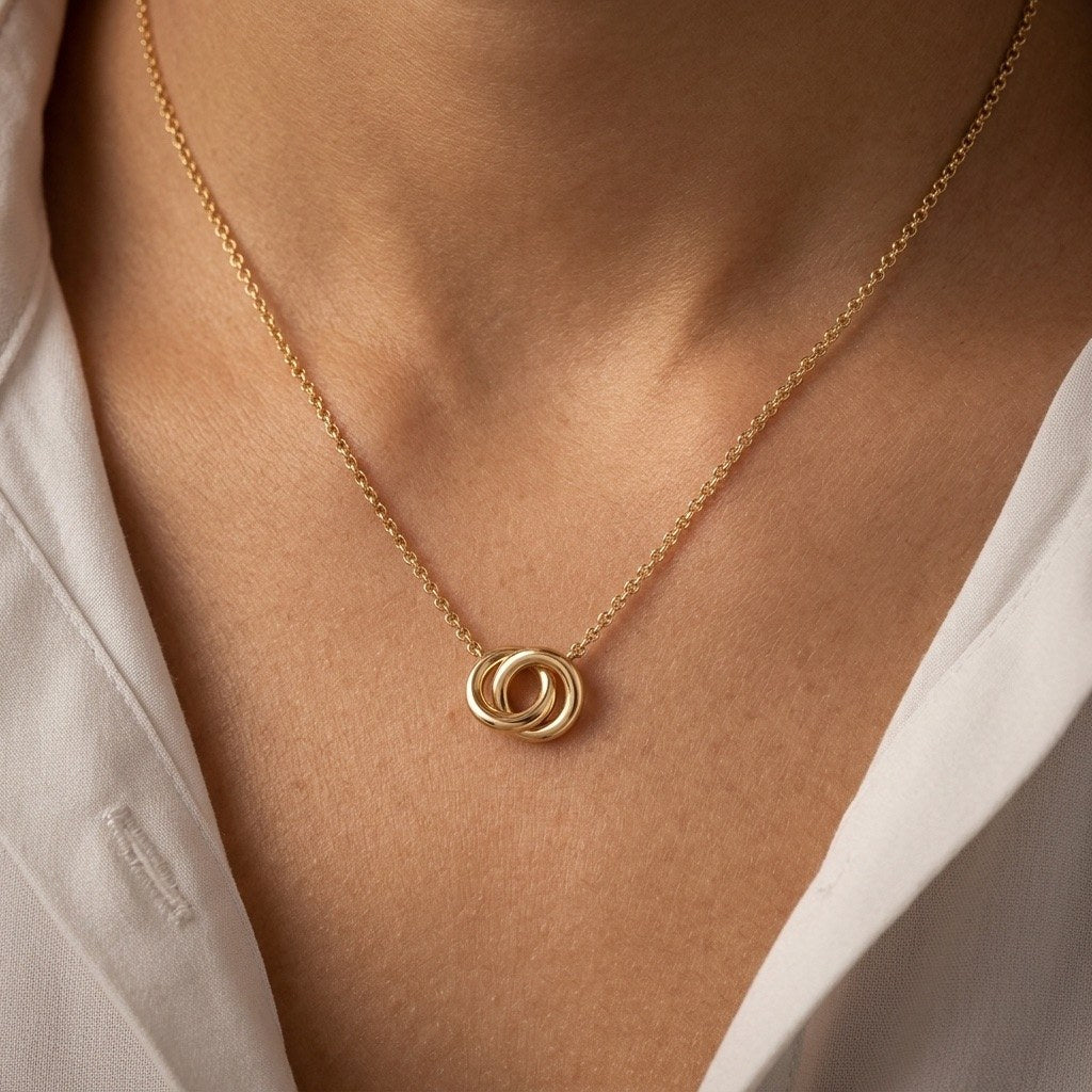 linked circle pendant necklace with polished interlocking rings creating a contemporary gold-tone design