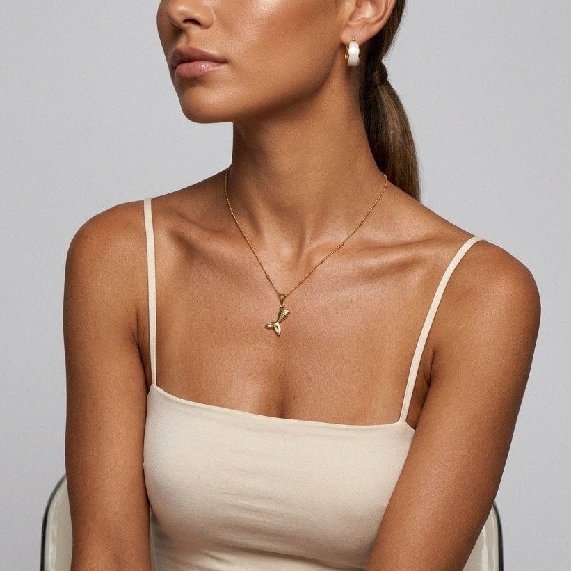 mermaid tail pendant necklace featuring a textured gold fin charm in a coastal design