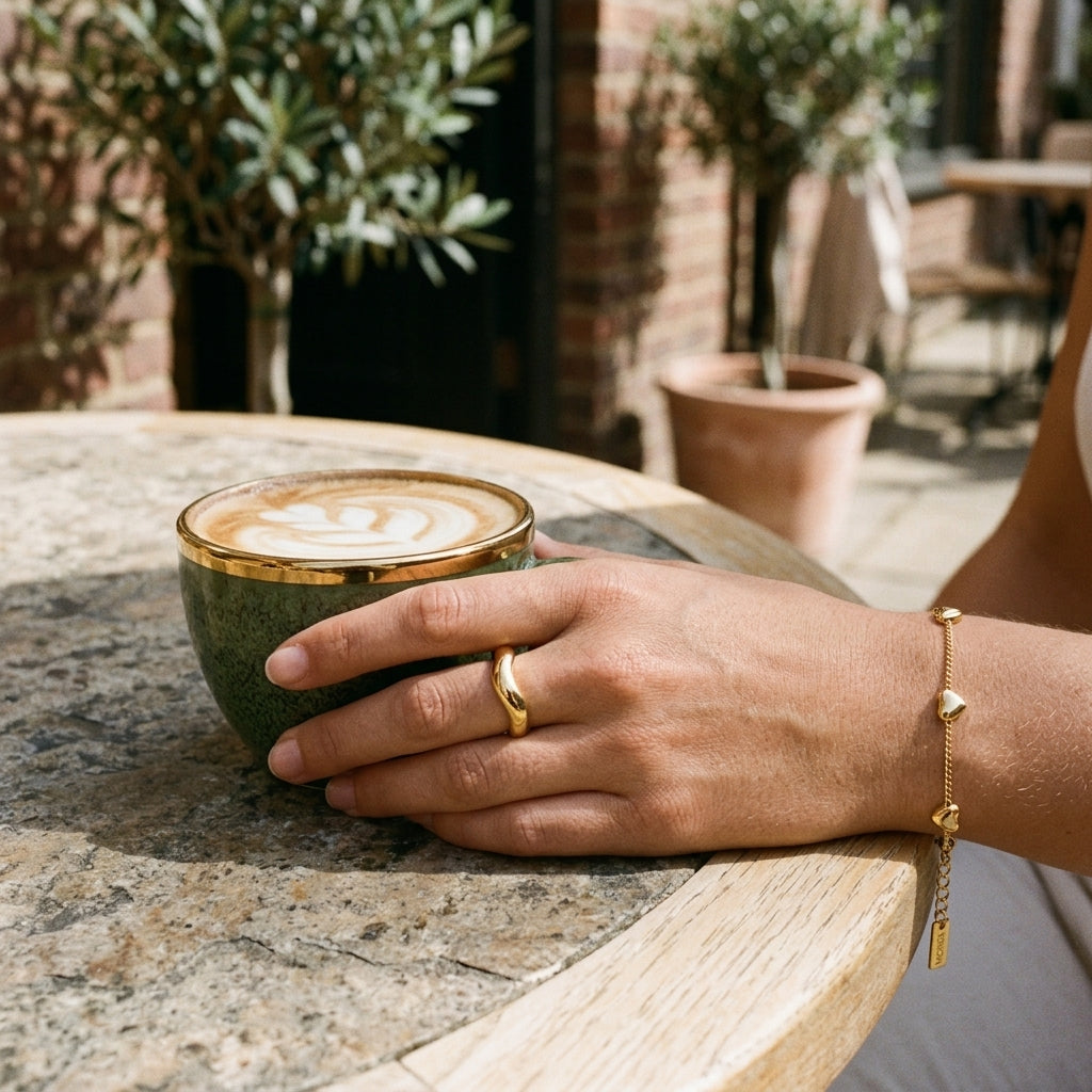 minimalist gold heart bracelet for women featuring tiny gold heart charms on a slender chain for a simple and romantic everyday jewelry look