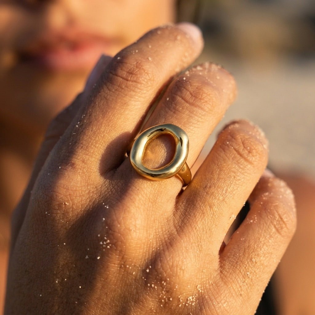 modern gold ring with a sculptural open design and smooth rounded profile