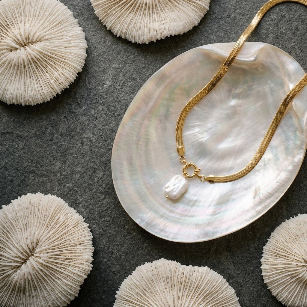 modern pearl drop necklace with a rectangular pearl pendant and sleek gold-tone choker-style chain